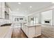 Open floor plan kitchen with stainless steel appliances, white cabinets, and quartz countertops at 2536 Wesley Ln, Lafayette, CO 80026
