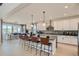 Bright, open kitchen with white cabinetry, an island with seating, and stainless steel appliances at 2536 Wesley Ln, Lafayette, CO 80026