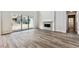 Bright living room area with hardwood floors, fireplace and sliding glass doors to the backyard at 2536 Wesley Ln, Lafayette, CO 80026