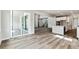 Spacious living room featuring wood floors, sliding glass doors, and an open floor plan leading to the kitchen at 2536 Wesley Ln, Lafayette, CO 80026