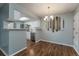 Dining area with kitchen pass-through and wood floors at 8335 Fairmount Dr # 3-201, Denver, CO 80247