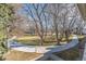 Landscaped grounds with a curved walkway and mature trees at 8335 Fairmount Dr # 3-201, Denver, CO 80247