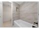 Bathroom with bathtub featuring stylish tile and storage nook at 7335 E Quincy Ave # 104, Denver, CO 80237