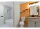 Bright bathroom featuring granite countertops, bathtub and tiled walls at 7335 E Quincy Ave # 104, Denver, CO 80237