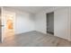 Bright room features wood-look flooring, a closet, and ensuite bathroom entrance at 7335 E Quincy Ave # 104, Denver, CO 80237