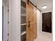 Hallway featuring a large barn door and closet space at 7335 E Quincy Ave # 104, Denver, CO 80237