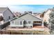 An elevated aerial view of the back of the home with a patio and fenced in back yard at 3906 S Quemoy Ct, Aurora, CO 80018