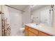 Bright bathroom with tub shower combo, wood cabinet and mirror at 3906 S Quemoy Ct, Aurora, CO 80018