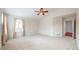 Large primary bedroom with vaulted ceiling, neutral paint and carpet, and bright window at 3906 S Quemoy Ct, Aurora, CO 80018