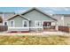 Back exterior view of home, showing siding, windows, and patio at 3906 S Quemoy Ct, Aurora, CO 80018