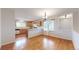 Eat-in kitchen boasting stylish wood floors, white countertops, and matching wooden cabinetry at 3906 S Quemoy Ct, Aurora, CO 80018