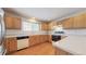 Bright kitchen features wooden cabinets, white countertops and island, and hardwood flooring at 3906 S Quemoy Ct, Aurora, CO 80018