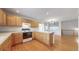 Bright kitchen features wooden cabinets, white countertops and island, and hardwood flooring at 3906 S Quemoy Ct, Aurora, CO 80018