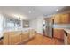 Kitchen with stainless refrigerator, wood cabinets and drawers, and white countertops at 3906 S Quemoy Ct, Aurora, CO 80018