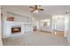 Bright and airy living room with a fireplace, high ceilings, and large windows at 3906 S Quemoy Ct, Aurora, CO 80018