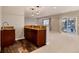 Finished basement bar with wet bar, cabinets, and sliding glass door access to backyard at 60 Golden Eagle Rd, Greenwood Village, CO 80121