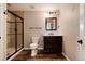 Basement bathroom with walk-in shower, toilet, vanity, and tile flooring at 60 Golden Eagle Rd, Greenwood Village, CO 80121