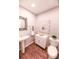 Elegant powder room with pedestal sink, modern cabinet, and decorative art at 60 Golden Eagle Rd, Greenwood Village, CO 80121