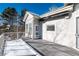 Deck with snow, offering a view of the backyard and trees at 60 Golden Eagle Rd, Greenwood Village, CO 80121