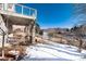 Elevated deck with stone pillars and view of backyard and open space at 60 Golden Eagle Rd, Greenwood Village, CO 80121