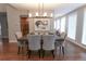 Dining room featuring a modern chandelier and stylish upholstered chairs set around a dark wood table at 60 Golden Eagle Rd, Greenwood Village, CO 80121