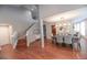 Elegant dining area with hardwood floors, stylish chandelier and comfortable upholstered chairs around a dark wood table at 60 Golden Eagle Rd, Greenwood Village, CO 80121