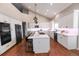 Modern kitchen with white cabinetry, stainless steel appliances, and spacious island at 60 Golden Eagle Rd, Greenwood Village, CO 80121