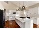 Modern kitchen with white cabinets, island, and high ceilings at 60 Golden Eagle Rd, Greenwood Village, CO 80121