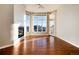 Bright living room with fireplace, large windows, and hardwood floors at 60 Golden Eagle Rd, Greenwood Village, CO 80121