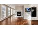 Cozy living room with a marble fireplace, lots of windows for natural light and hardwood floors at 60 Golden Eagle Rd, Greenwood Village, CO 80121