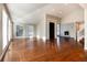 Sunlit living room with hardwood floors, high ceilings, and an open floor plan at 60 Golden Eagle Rd, Greenwood Village, CO 80121