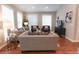 Comfortable living room with a variety of seating options and natural light from the windowed walls at 60 Golden Eagle Rd, Greenwood Village, CO 80121