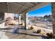 Covered patio with stone pillars, offering a view of the backyard and open space at 60 Golden Eagle Rd, Greenwood Village, CO 80121