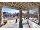 Covered patio with stone pillars and a view of the backyard at 60 Golden Eagle Rd, Greenwood Village, CO 80121