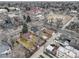 Aerial view of the neighborhood and charming brick home with fenced yard at 4850 E 18Th Ave, Denver, CO 80220