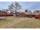 View of the detached garage, yard, and privacy fence at 4850 E 18Th Ave, Denver, CO 80220