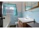 Cozy bathroom featuring a sink, toilet, and window with blue tile accents for a classic aesthetic at 4850 E 18Th Ave, Denver, CO 80220