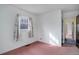 Another view of the bedroom with a vintage light fixture, one window, and salmon colored carpeting at 4850 E 18Th Ave, Denver, CO 80220