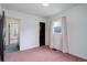 This bedroom features two doorways, one window, and a pink carpet at 4850 E 18Th Ave, Denver, CO 80220