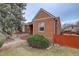 Charming single-story brick home featuring a well-kept lawn and a neatly landscaped front yard at 4850 E 18Th Ave, Denver, CO 80220