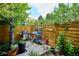 Landscaped backyard featuring a grill, wooden fence and a charming patio area for outdoor enjoyment at 2723 Galena St, Denver, CO 80238