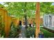 Lush backyard with a stone pathway, pergola patio, and a designated grilling area offering a tranquil outdoor escape at 2723 Galena St, Denver, CO 80238