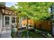 Beautifully landscaped backyard with a pergola-covered patio, lush greenery, and manicured lawn for serene outdoor living at 2723 Galena St, Denver, CO 80238
