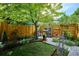 Relaxing backyard featuring a garden, a barbecue grill, and a lush green lawn at 2723 Galena St, Denver, CO 80238