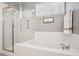 Bathroom featuring a shower, soaking tub, and bright natural light from the adjacent window at 2723 Galena St, Denver, CO 80238
