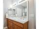 Bathroom with a double sink vanity, white cabinets, and a large mirror over the countertop at 2723 Galena St, Denver, CO 80238