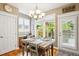 Open dining area with stylish decor, a view to outdoor area, and natural light and hardwood floors at 2723 Galena St, Denver, CO 80238