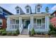 Charming home featuring a welcoming front porch, dormer windows, and well-manicured landscaping at 2723 Galena St, Denver, CO 80238