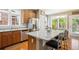 Bright kitchen featuring stainless steel appliances, a granite island with seating, and ample natural light at 2723 Galena St, Denver, CO 80238