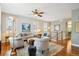 Bright living room with hardwood floors, ceiling fan, and natural light from shuttered windows at 2723 Galena St, Denver, CO 80238